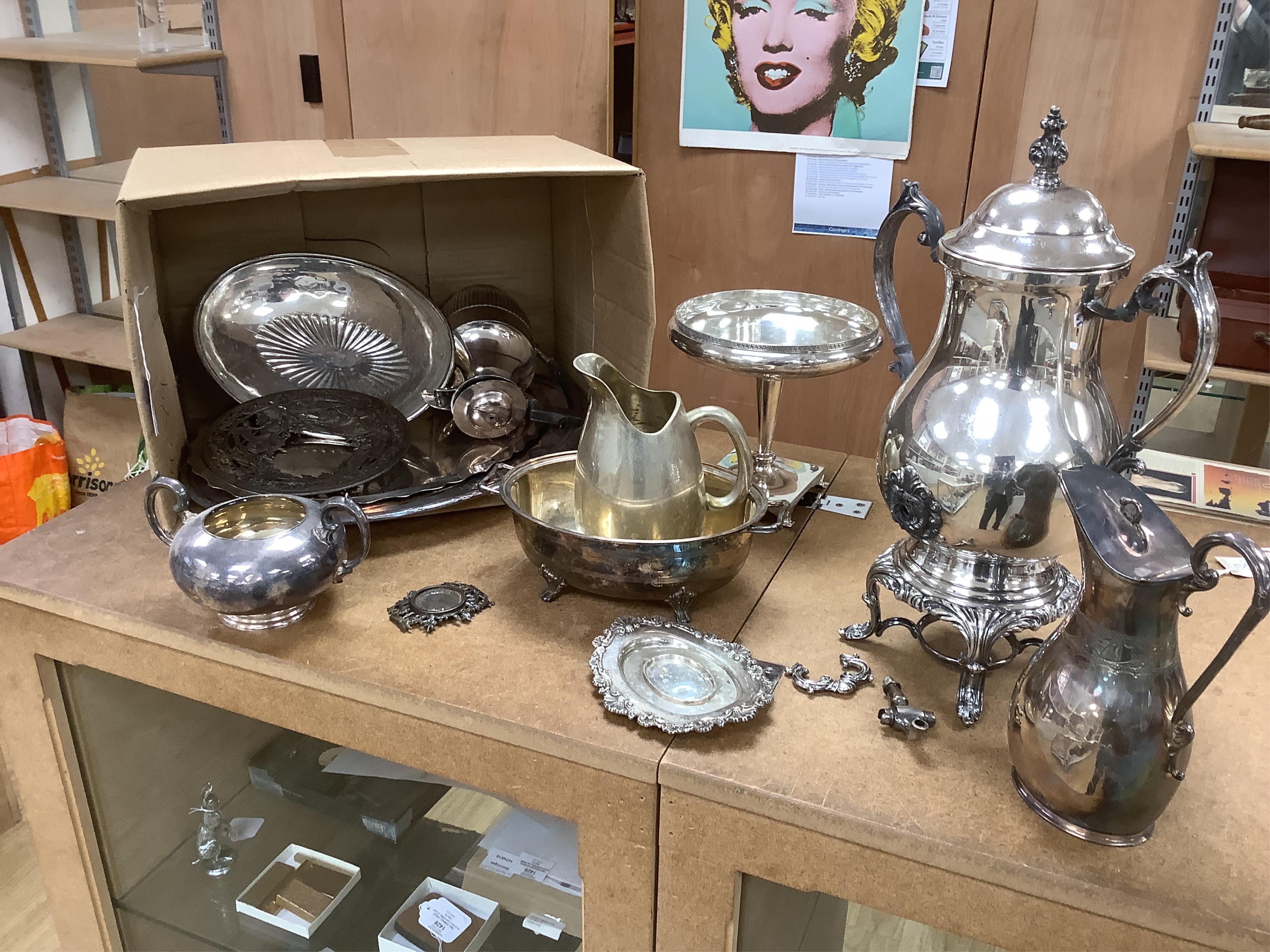 Two boxes of plated ware including a tall candlestick, a two handled tray and two galleried trays. Condition - fair